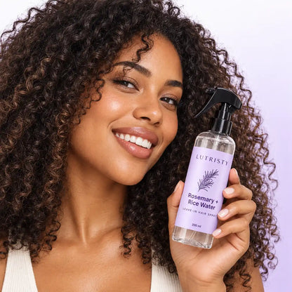 Lutristy Hair Ritual held beside naturally curly hair.
